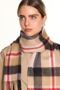 A luxurious display of soft pastel and neutral-toned Scottish cashmere scarves elegantly arranged as Mother’s Day gifts.