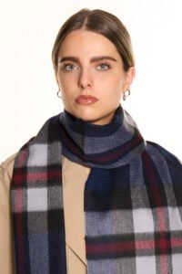 A navy plaid cashmere scarf in a luxury handcrafted gift box.