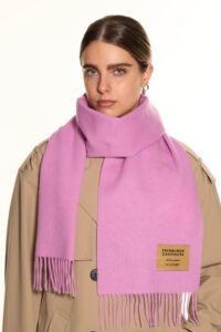 Neutral-toned cashmere scarves arranged in a luxury boutique setting