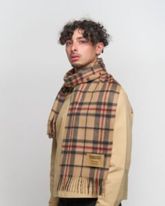 Artisan hands weaving Scottish cashmere on a traditional loom, showcasing premium material.